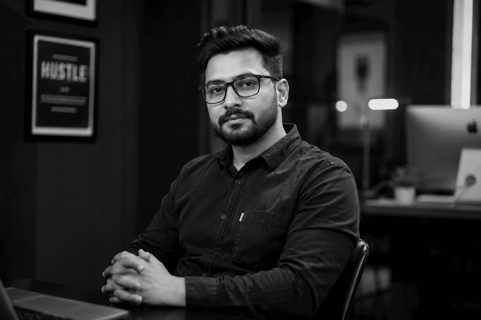 Professional man working at a desk in a modern office environment.